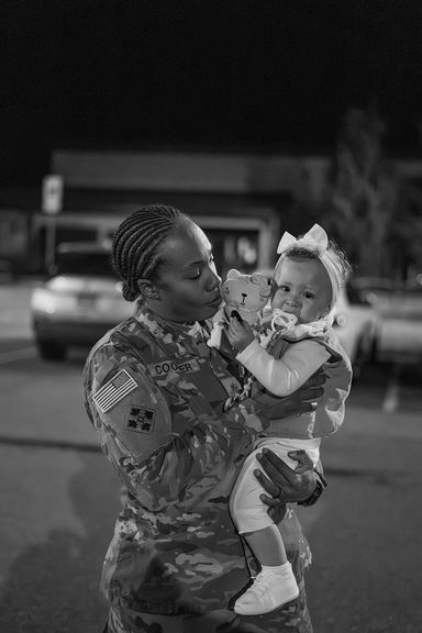 Service member holding her baby after returning home from deployment