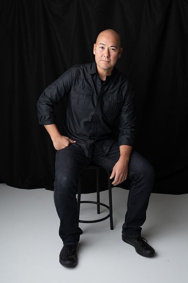 Man seated for a modern professional studio portrait