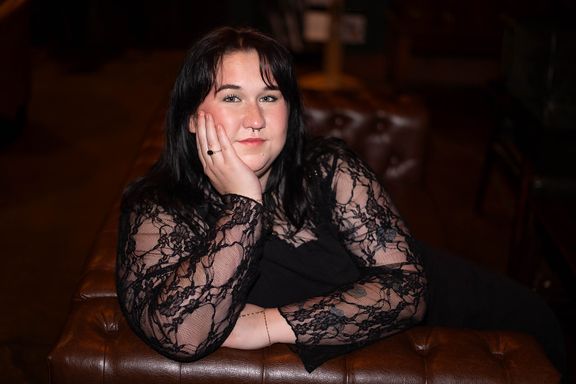 Woman posing in a warm indoor setting during a personal branding session