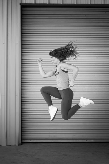 Black and white action portrait of a woman during a personal branding session