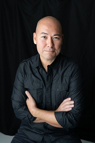 Man in black shirt posing for a professional headshot in Colorado Springs