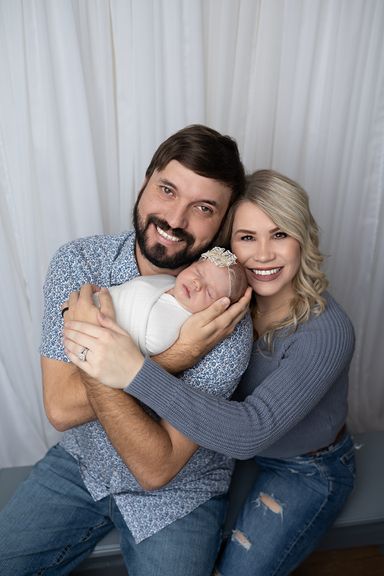 New parents holding their newborn baby during a family newborn photography session