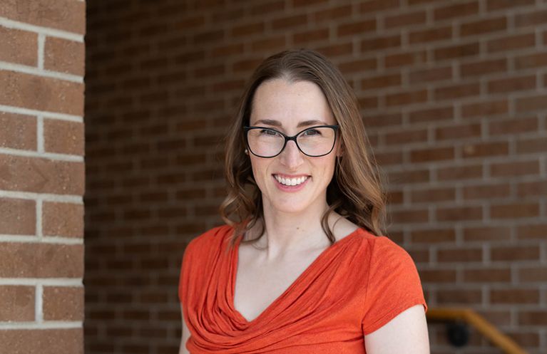 Professional headshot of a woman photographed indoors in Colorado Springs