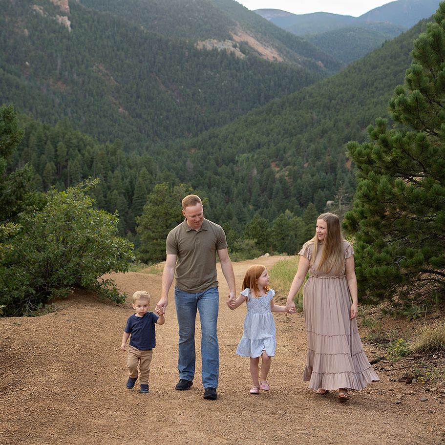 Family of four walking together in the Colorado mountains during a relaxed family photography session