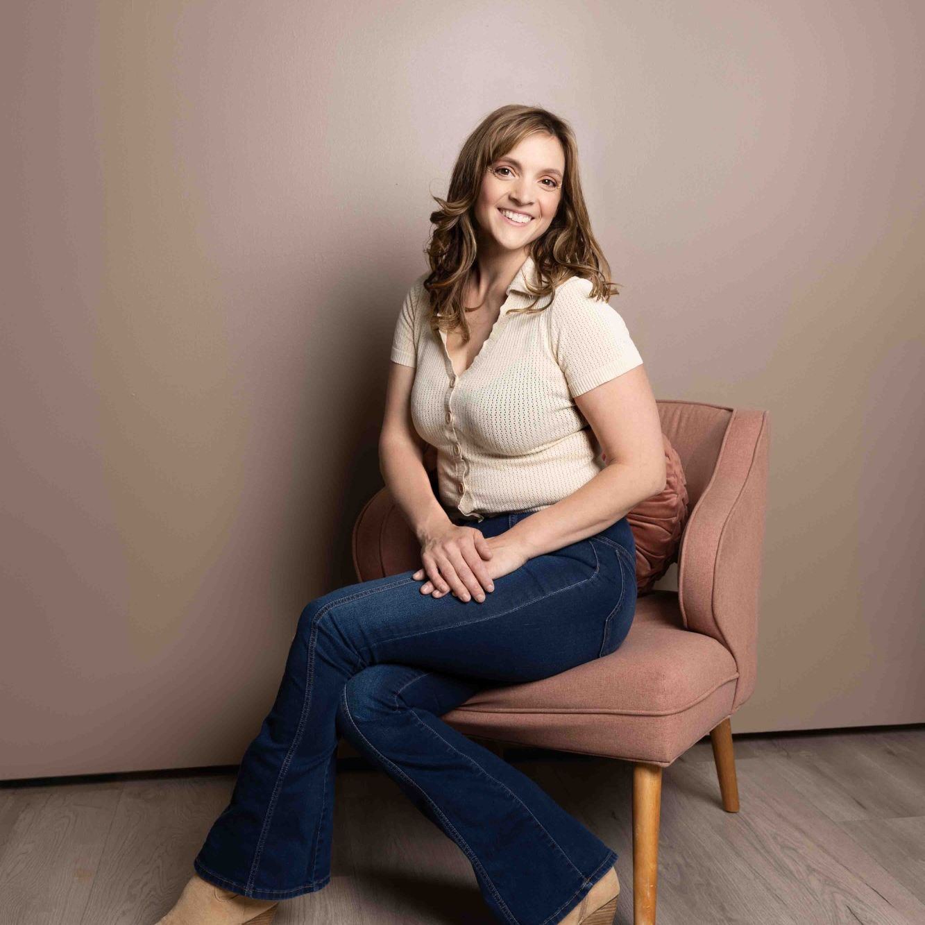 Colorado Springs photographer and brand designer Emma seated in a photography studio