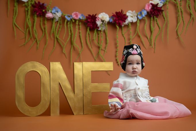Baby celebrating her first birthday during a colorful milestone photography session in Colorado Springs.