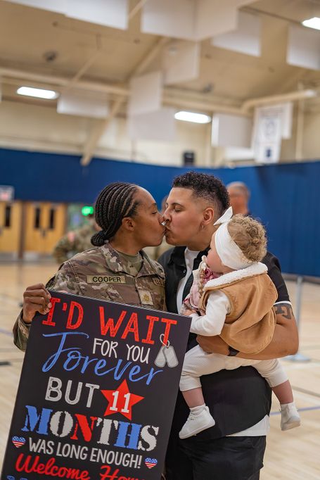 Military family embracing during an emotional homecoming reunion photographed in Colorado Springs.