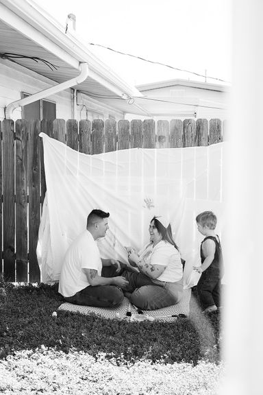 Black and white candid family portrait during an at-home photography session