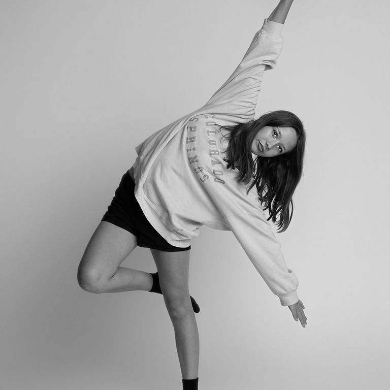 Black and white portrait of a young dancer posing during a studio photography session
