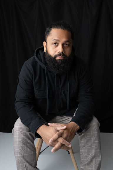 Male professional seated for a relaxed personal branding portrait