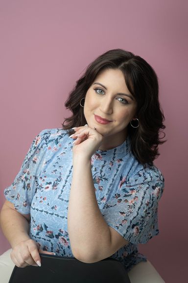 Woman in floral blouse posing for a relaxed professional headshot