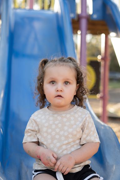 Young child playing on a playground during a personality photography session