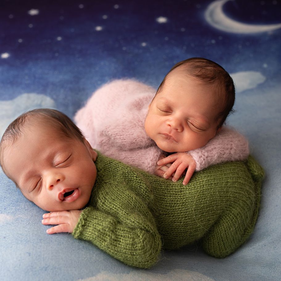 New parents holding their sleeping newborn baby during a family newborn photography session
