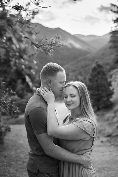 Black and white portrait of a couple embracing in the Colorado mountains