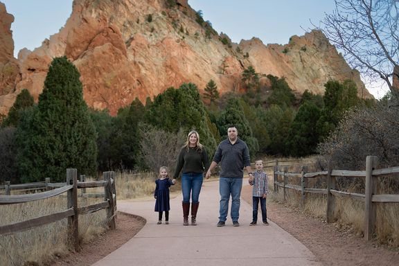 Family of four walking together at Garden of the Gods in Colorado Springs