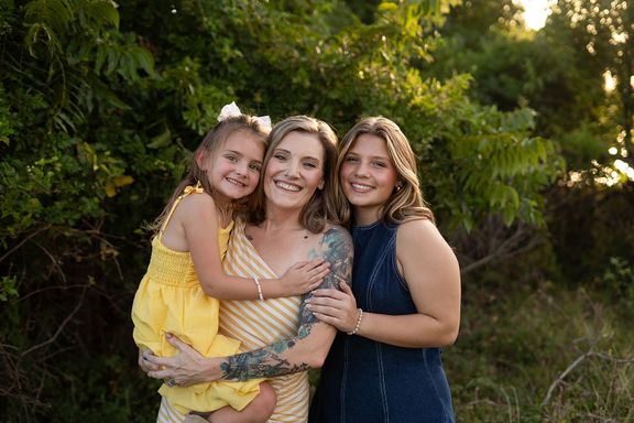 Mother with her daughters smiling together during a family photography session