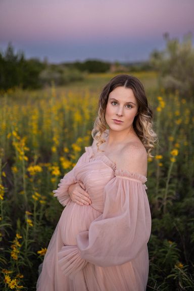 Expecting mother in a pink dress during an outdoor maternity photography session