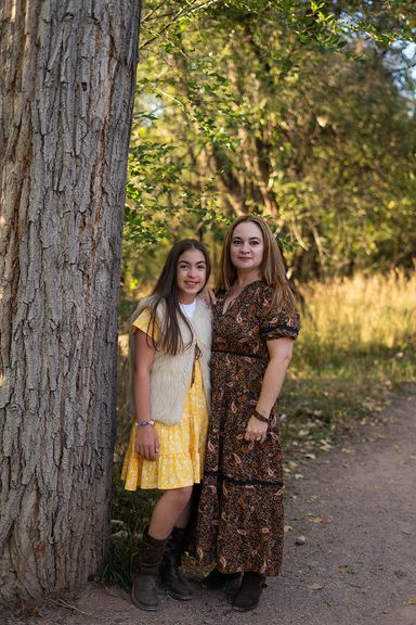 Mother daughter  standing together outdoors during a family photography session