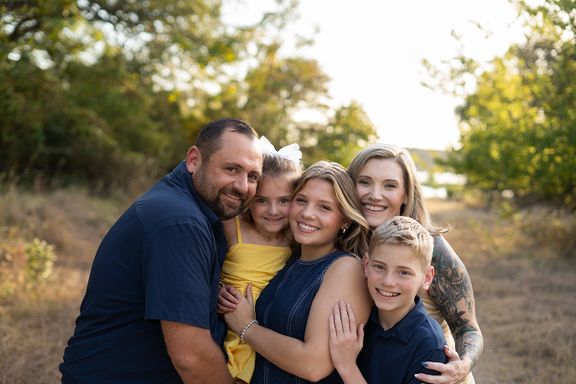 Family cuddling together during a golden-hour family photography session