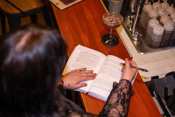 Personal branding detail photo of a woman reading at a bar