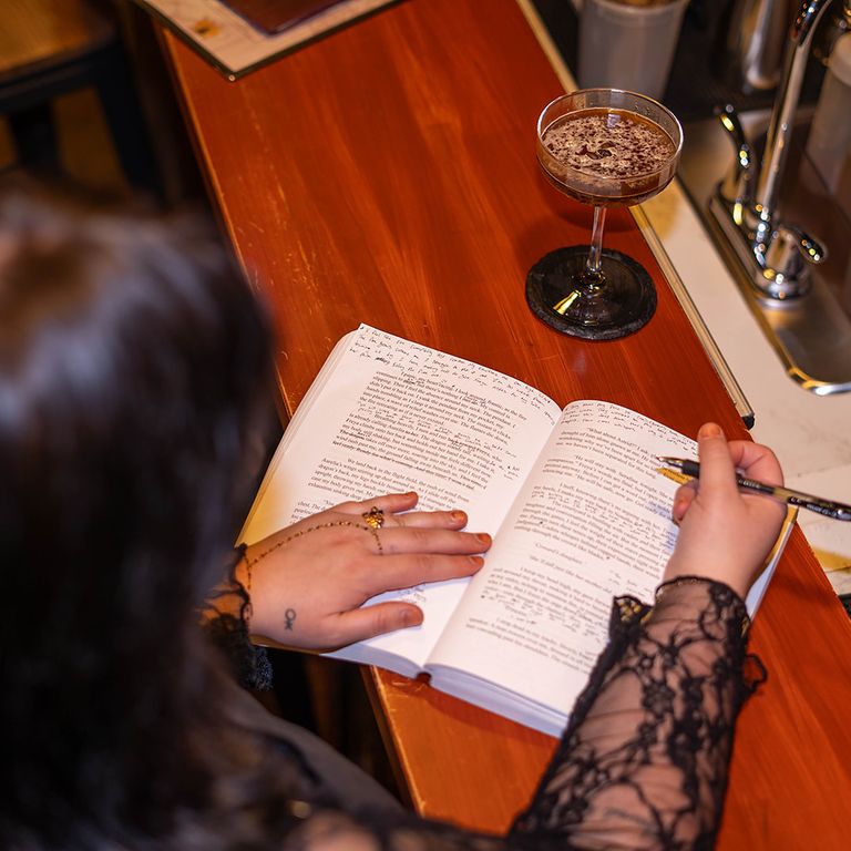 Personal branding detail photo of a business owner writing in a book during a Colorado Springs branding session