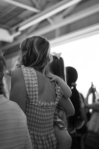 Child hugging their parent during a military homecoming reunion