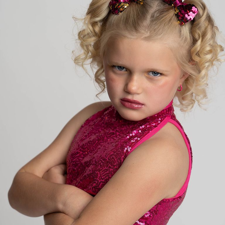 Young dancer showing her playful personality during a studio portrait session