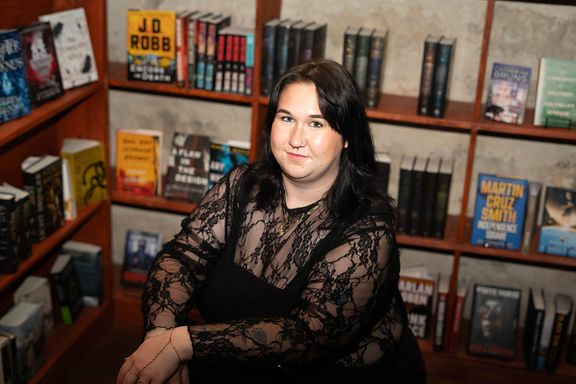 Female professional photographed in a bookstore for a personal branding session